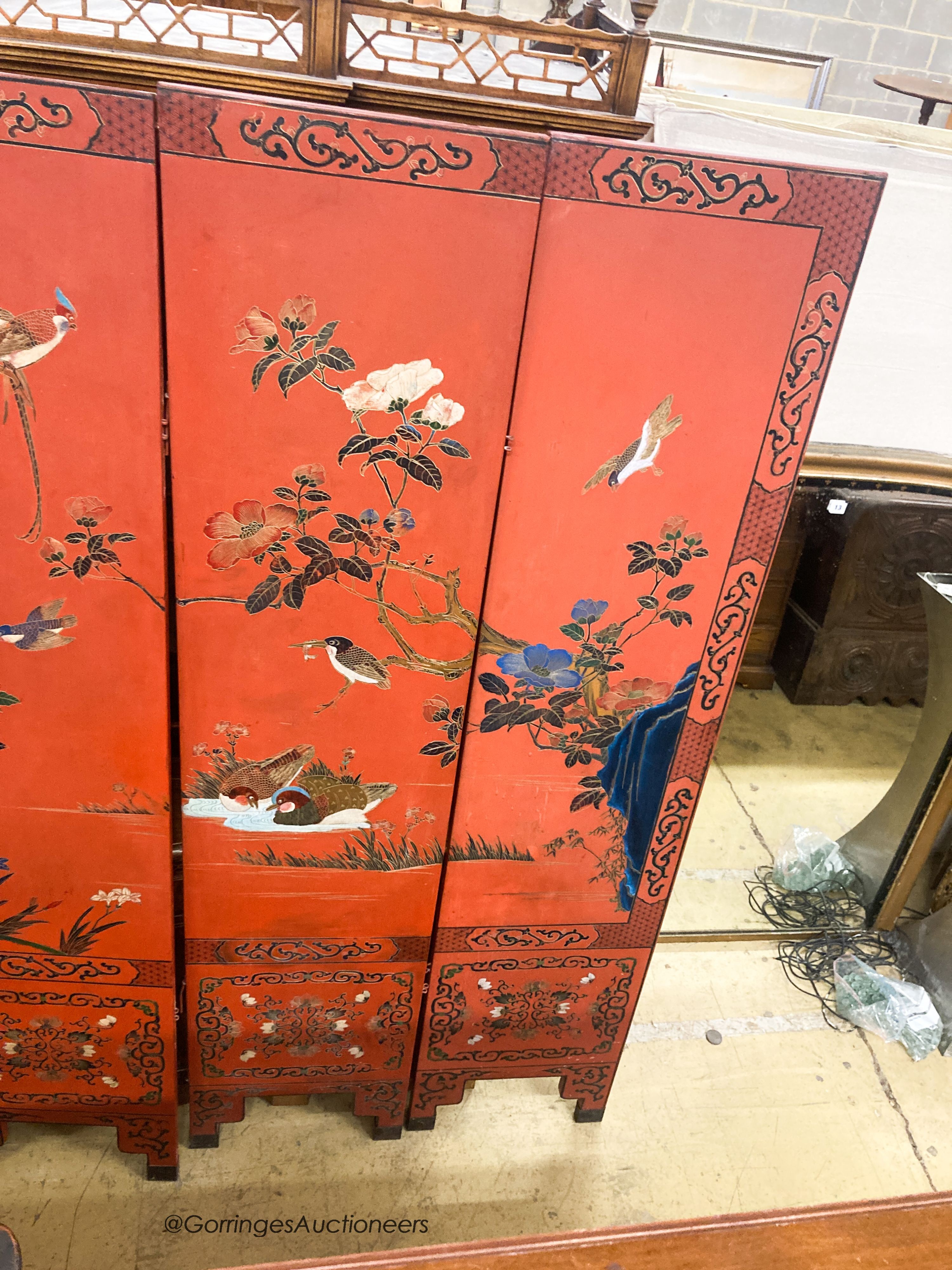 A Chinese red lacquered six fold screen, each panel W.41cm H.184cm